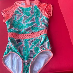 This is a target bathing suit, size 10/12. Its colors are pink, green.